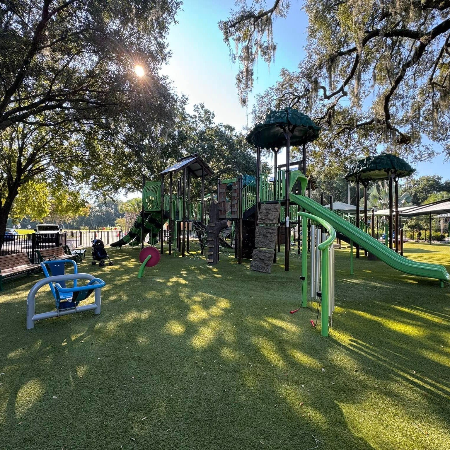 Municipal park playground with synthetic turf surfacing
